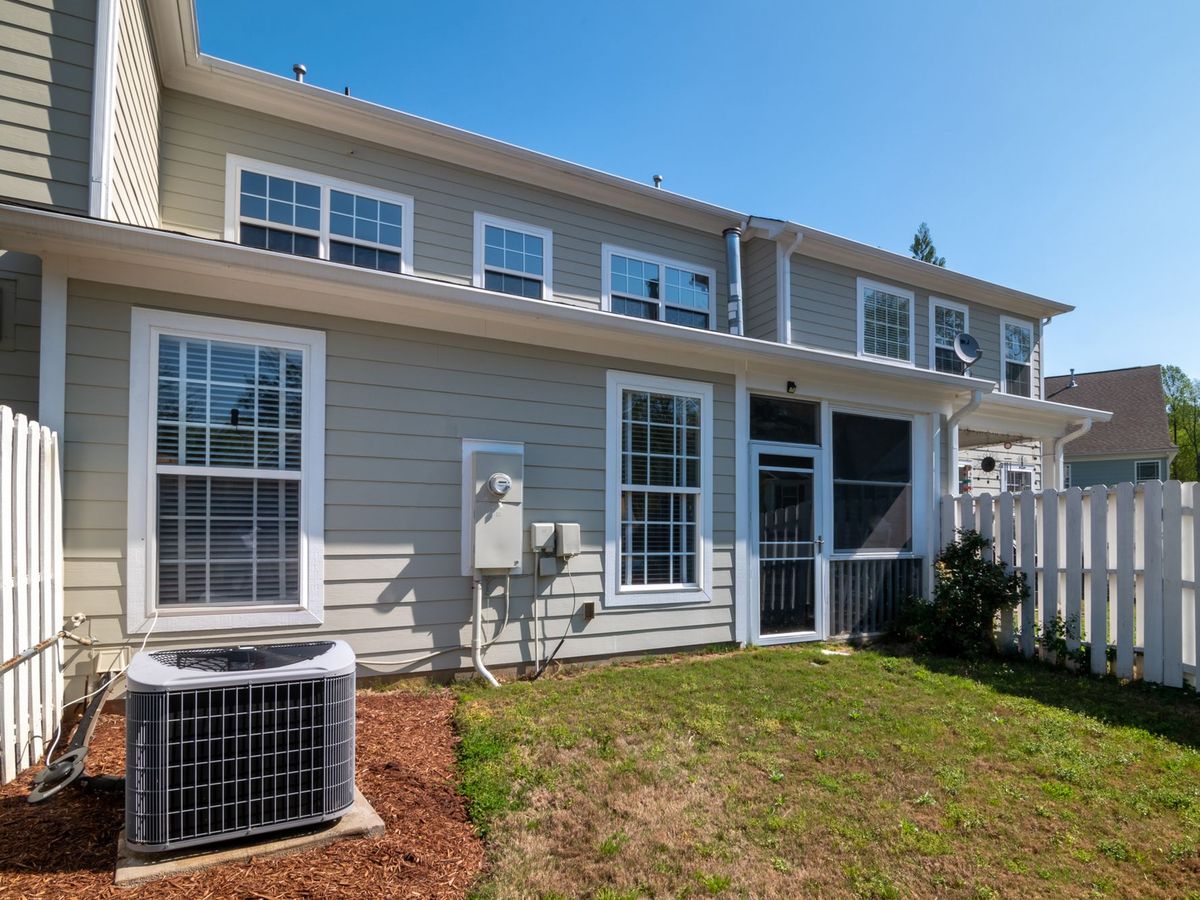 Outdoor air conditioner condenser beside a two-story home, residential HVAC in North Little Rock AR